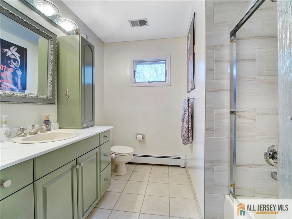 4 Cherokee Road East Brunswick, NJ 08816 - Photo 23 of 40 a bathroom with a sink a toilet and shower