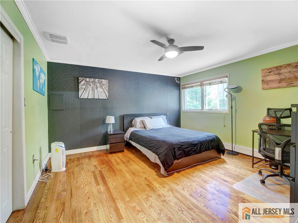 4 Cherokee Road East Brunswick, NJ 08816 - Photo 24 of 40 a bedroom with a bed and a table in it