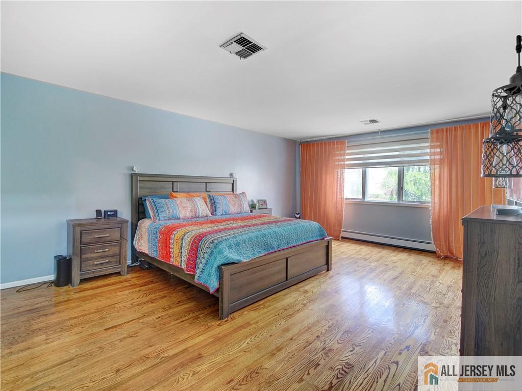 4 Cherokee Road East Brunswick, NJ 08816 - Photo 25 of 40 a bedroom with a large bed and a window