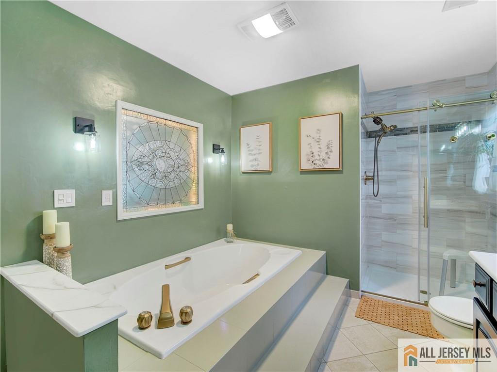 4 Cherokee Road East Brunswick, NJ 08816 - Photo 28 of 40 a bathroom with a tub a sink and glass door