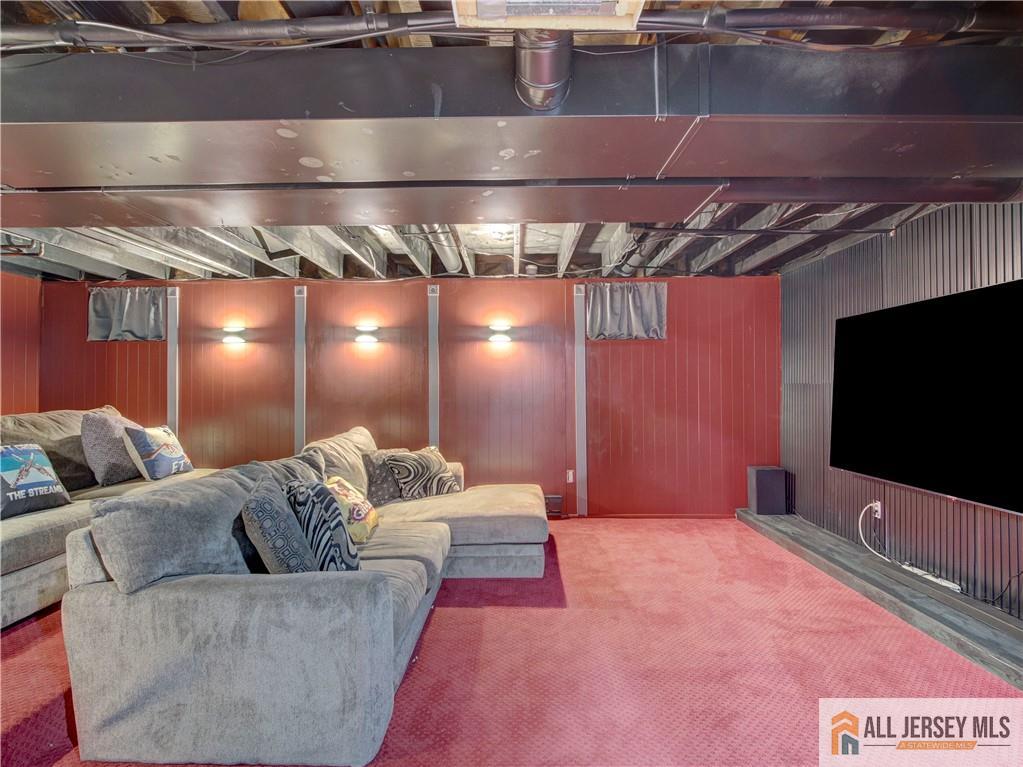 4 Cherokee Road East Brunswick, NJ 08816 - Photo 32 of 40 a living room with a couch and a flat screen tv