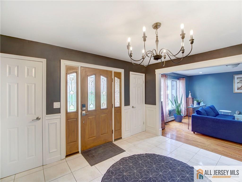 4 Cherokee Road East Brunswick, NJ 08816 - Photo 5 of 40 a living room with furniture and a chandelier
