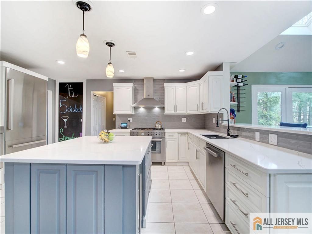 4 Cherokee Road East Brunswick, NJ 08816 - Photo 10 of 40 a large kitchen with kitchen island a sink stainless steel appliances and cabinets