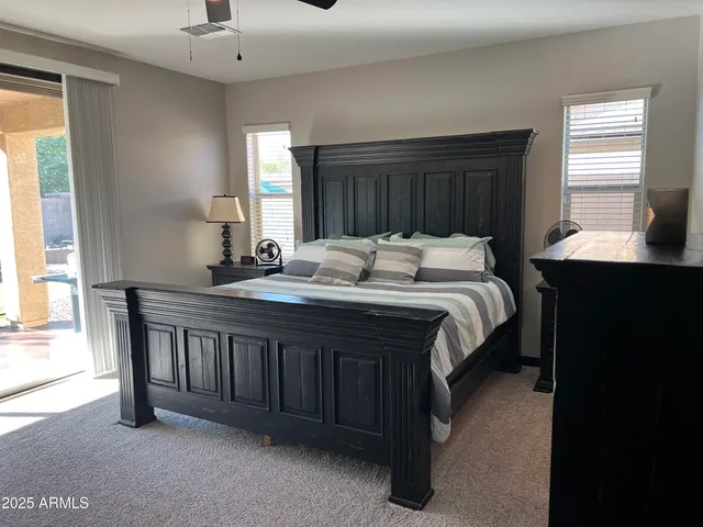 a bed room with a bed and a chair