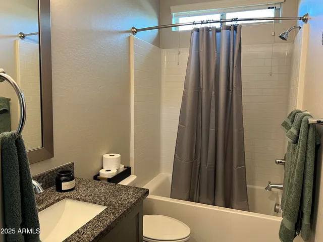 a livingroom with workspace and a window