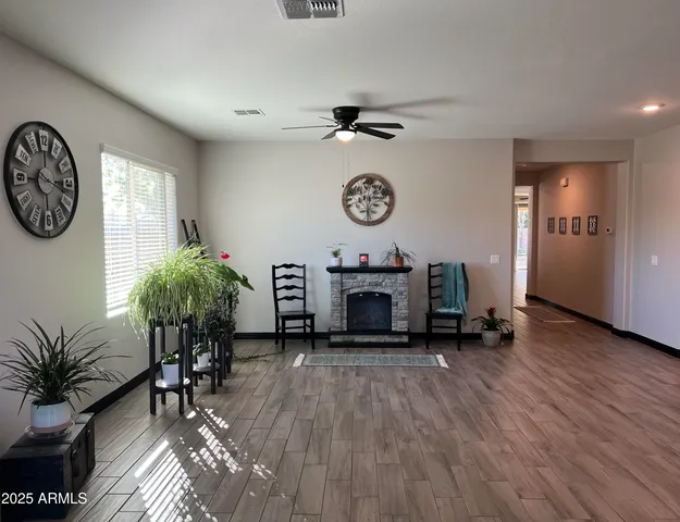 a view of a room with furniture and wooden floor