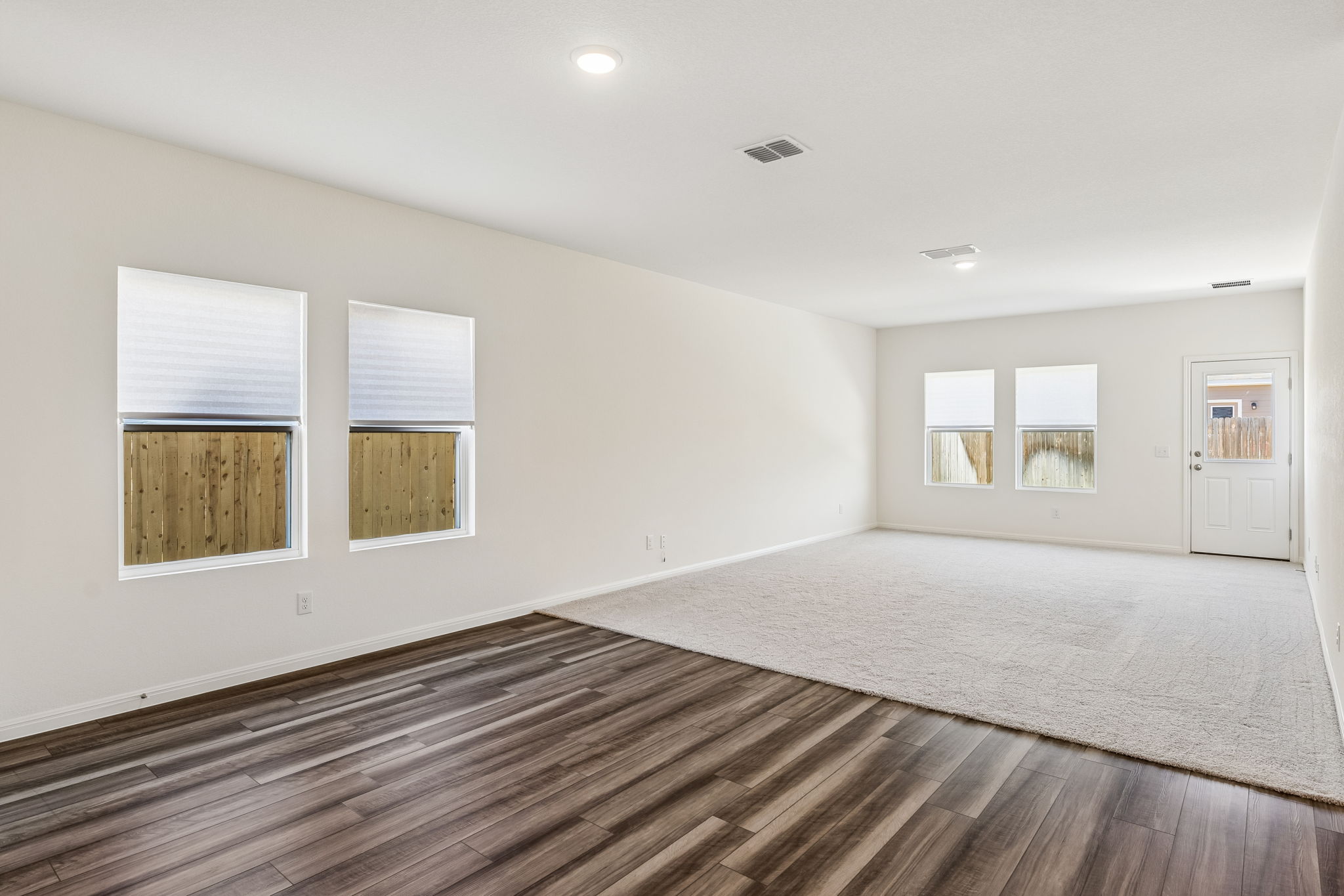 550 Thistle Lane Maxwell, TX 78656 - Photo 11 of 29 a view of an empty room with a window and wooden floor