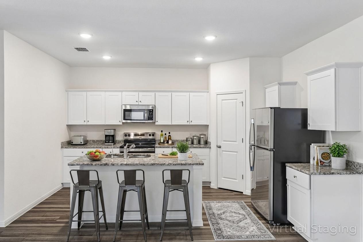 550 Thistle Lane Maxwell, TX 78656 - Photo 6 of 29 a kitchen with stainless steel appliances a refrigerator stove microwave and cabinets