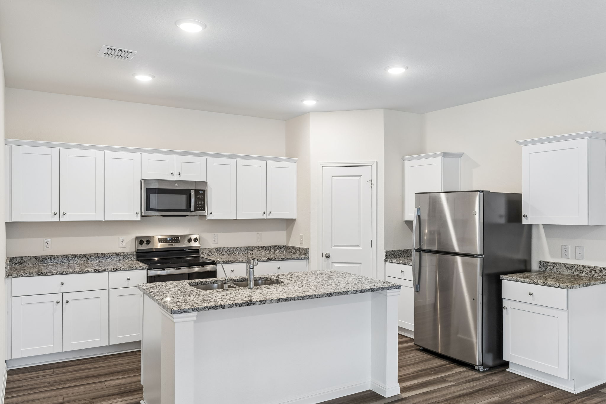 550 Thistle Lane Maxwell, TX 78656 - Photo 7 of 29 a kitchen with stainless steel appliances granite countertop a refrigerator stove a sink and a granite counter tops