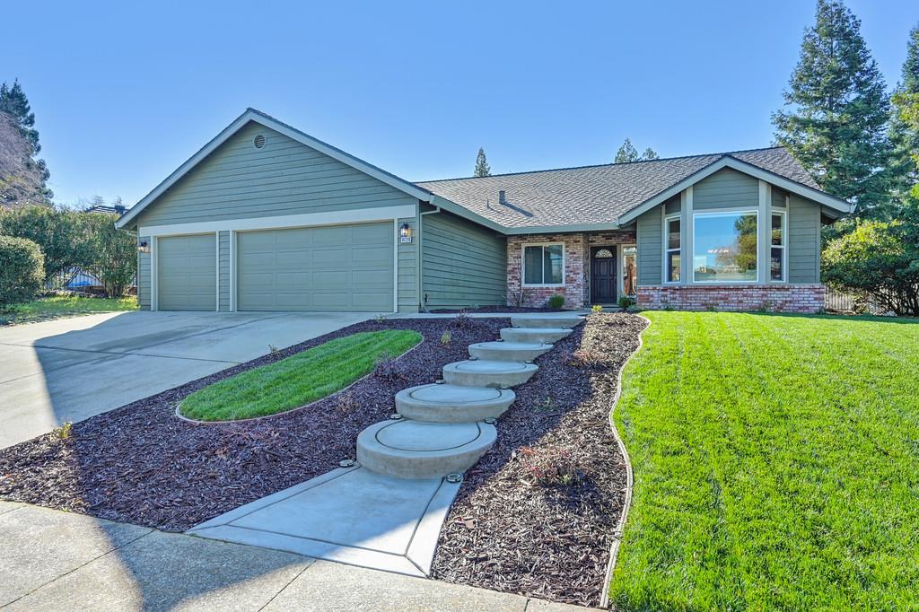 a front view of house with yard and green space
