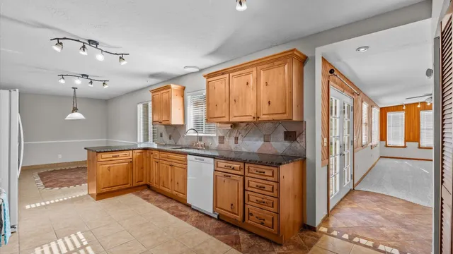 a large kitchen with stainless steel appliances granite countertop a large counter top and a stove
