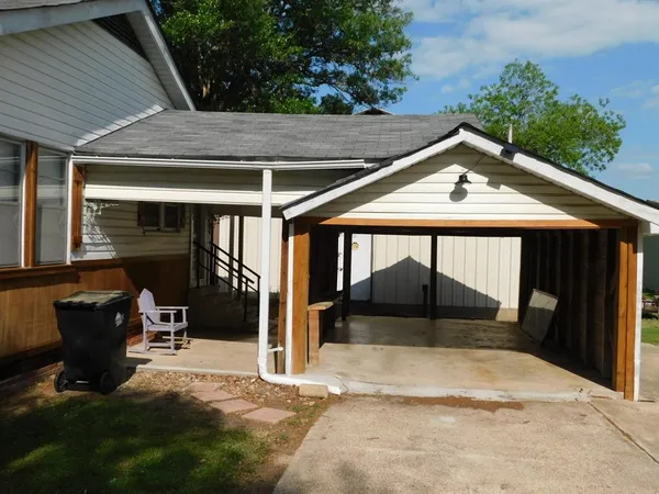 a backyard of a house with table and chairs