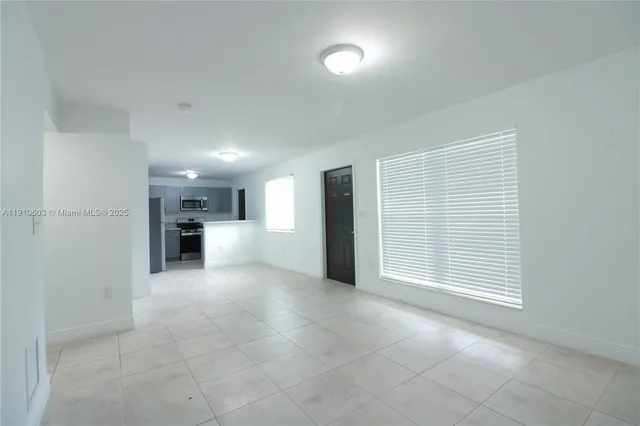a view of a kitchen with a sink and cabinets