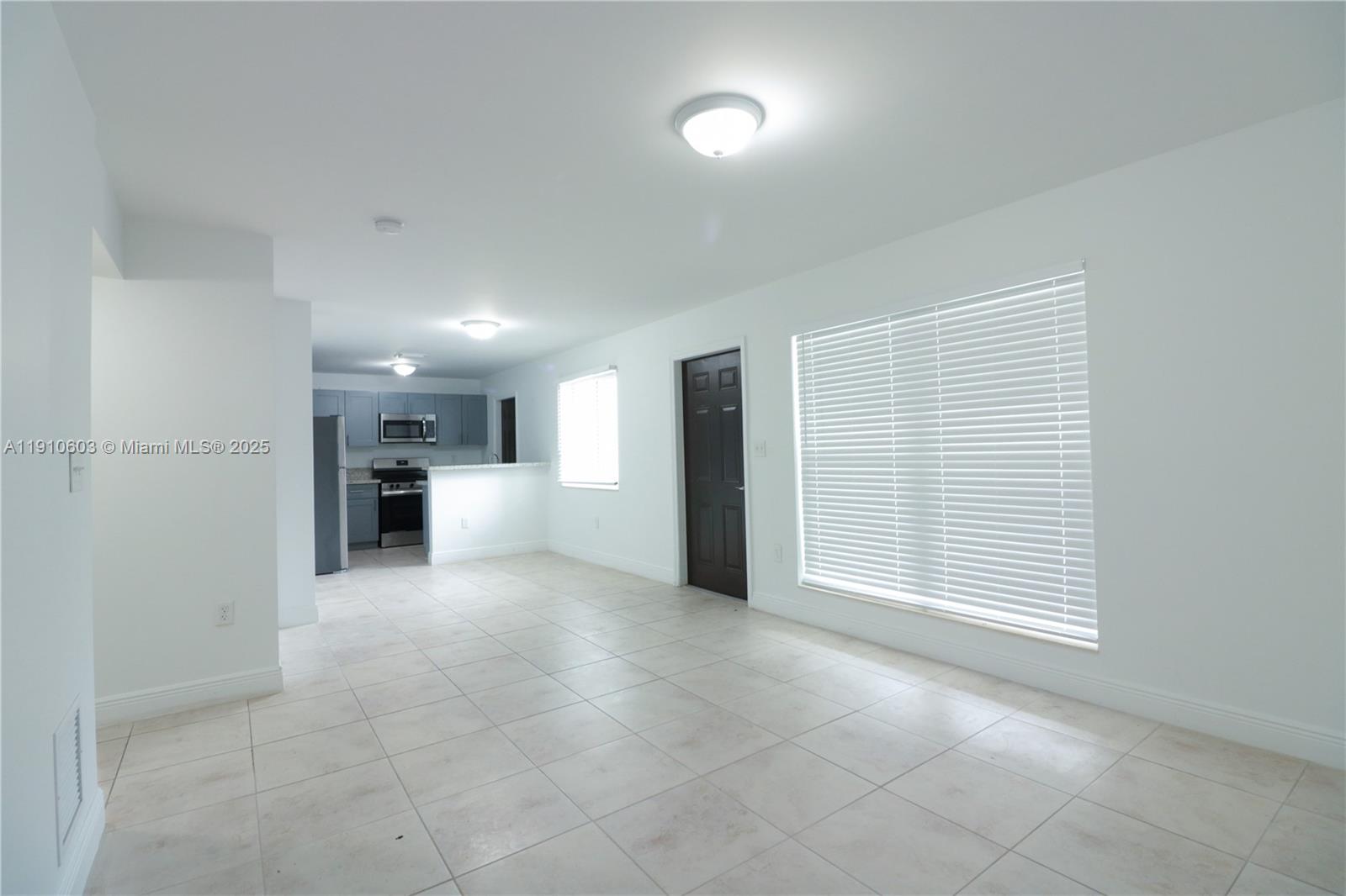 a view of a kitchen with a sink and cabinets