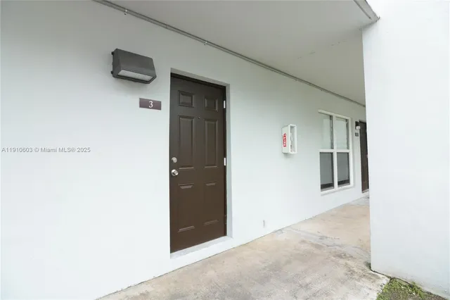 view of a hallway with wooden floor and a refrigerator
