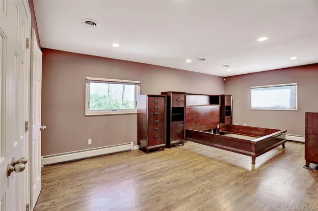 a living room with furniture flat screen tv and gym equipment