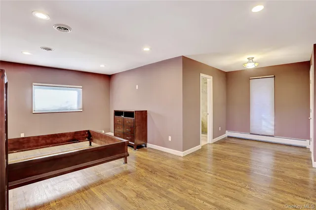 a view of room with window and wooden floor
