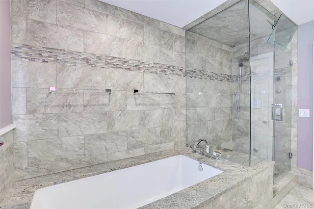 a bathroom with a bathtub and shower