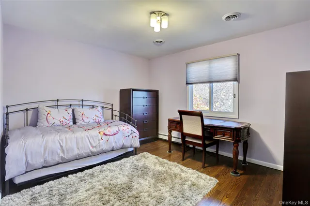 a bedroom with a bed window and a desk