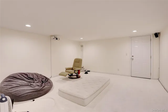 a living room with furniture and a gym equipment