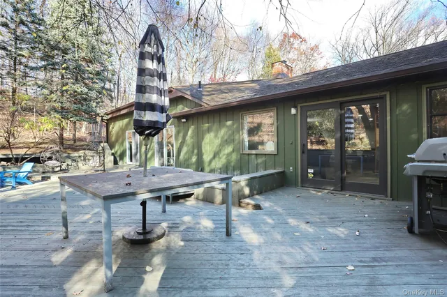 a view of a patio with table and chairs with wooden floor and fence