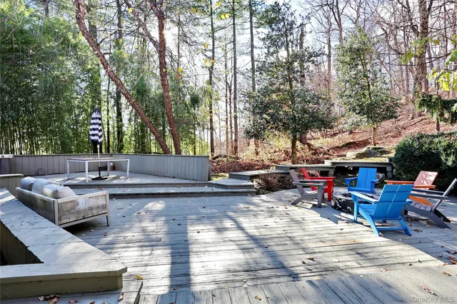 a view of backyard with swimming pool and sitting area