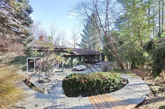 a view of a patio with table and chairs under an umbrella