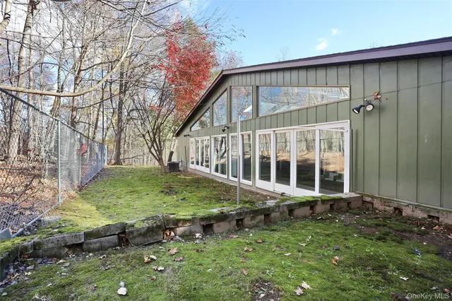 a backyard of a house with yard and outdoor seating