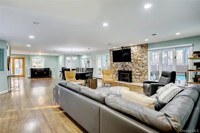 a living room with furniture a fireplace and a flat screen tv