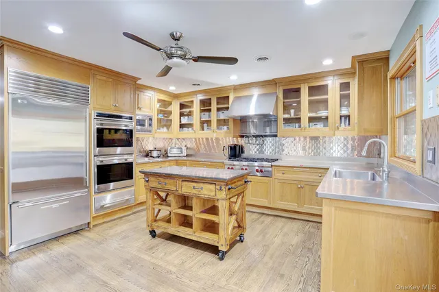 a kitchen with stainless steel appliances granite countertop a sink and cabinets