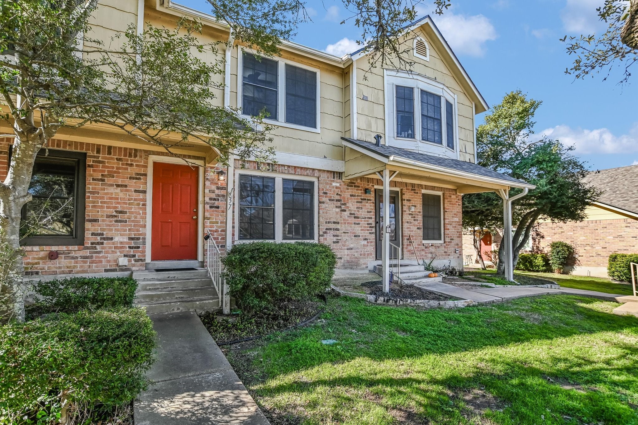 Undisclosed Address Austin, TX 78758 - Photo 1 of 19 a front view of a house with garden and porch