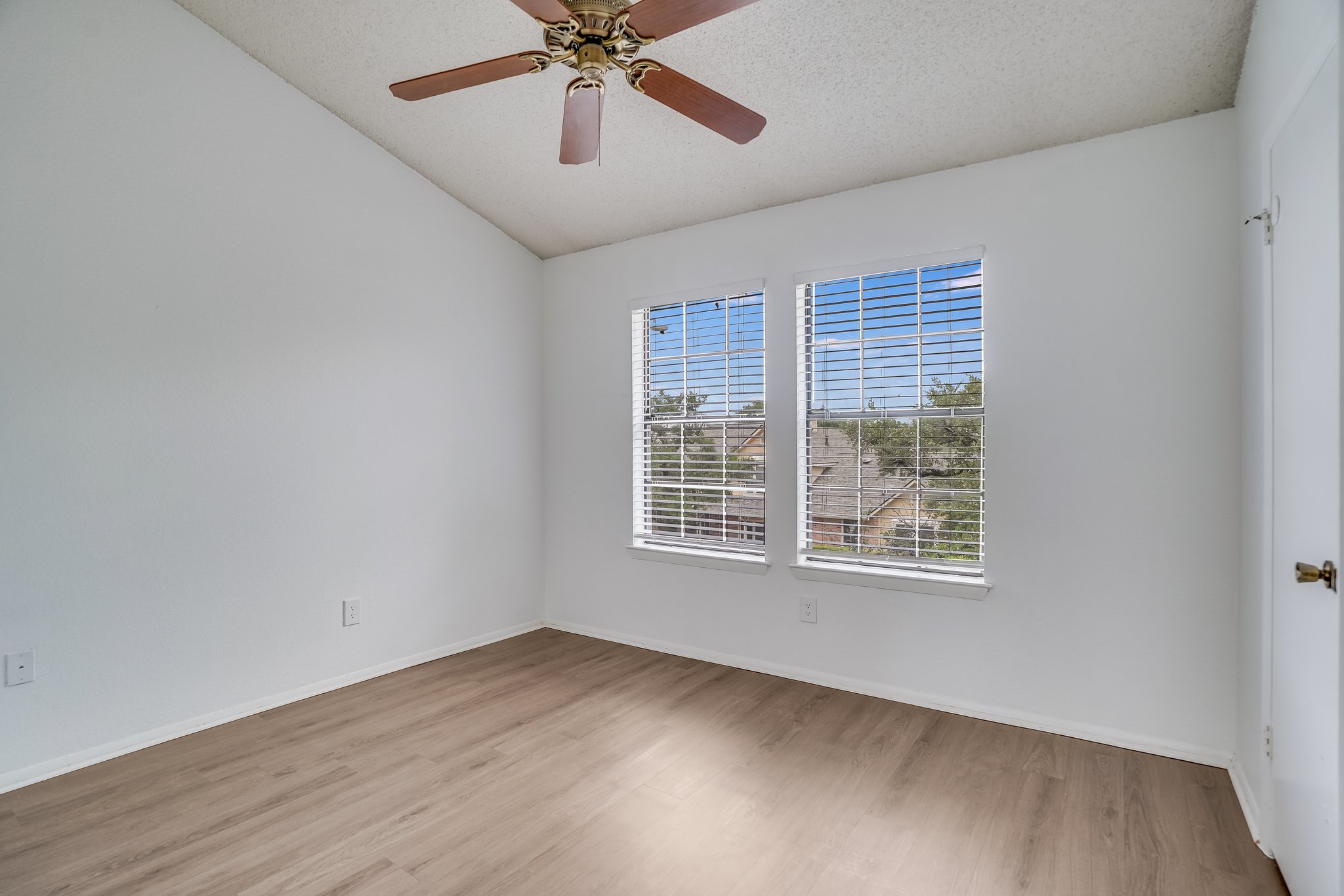 Undisclosed Address Austin, TX 78758 - Photo 10 of 19 a view of an empty room with a window and wooden floor