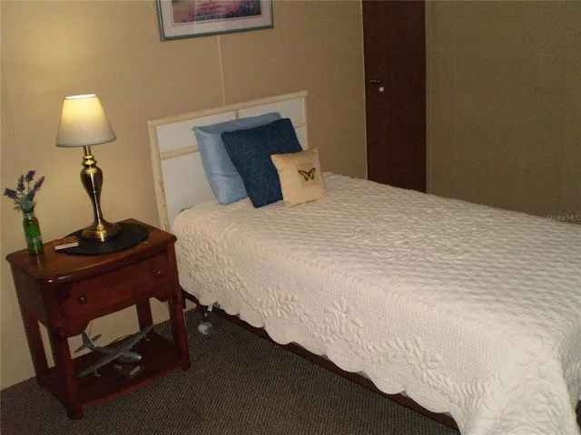 a bedroom with a bed and a lamp