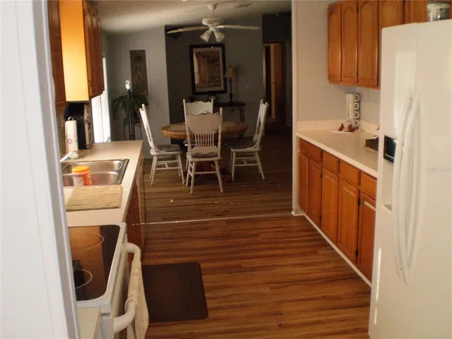 a dining room with wooden floor and entrance