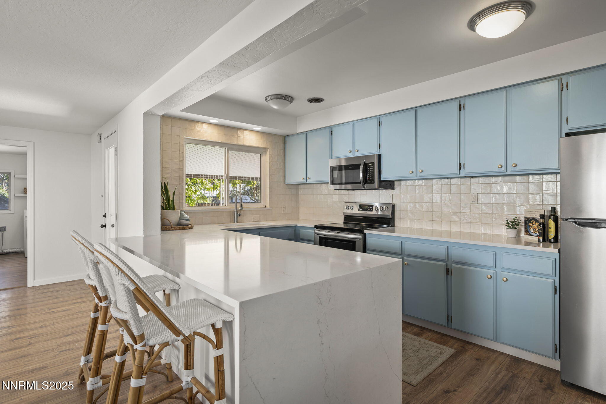 640 Robin Street Reno, NV 89509 - Photo 11 of 25 a kitchen with stainless steel appliances granite countertop a stove top oven a sink a refrigerator with a dining table and chairs