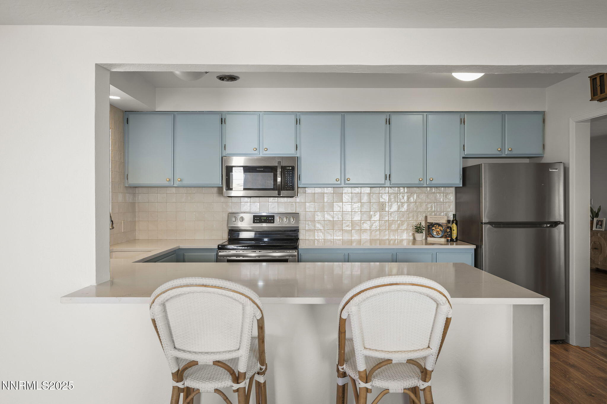 640 Robin Street Reno, NV 89509 - Photo 12 of 25 a kitchen with stainless steel appliances a refrigerator a sink a stove a table and chairs