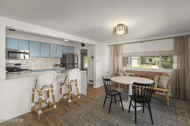 a view of a dining room with furniture and a window