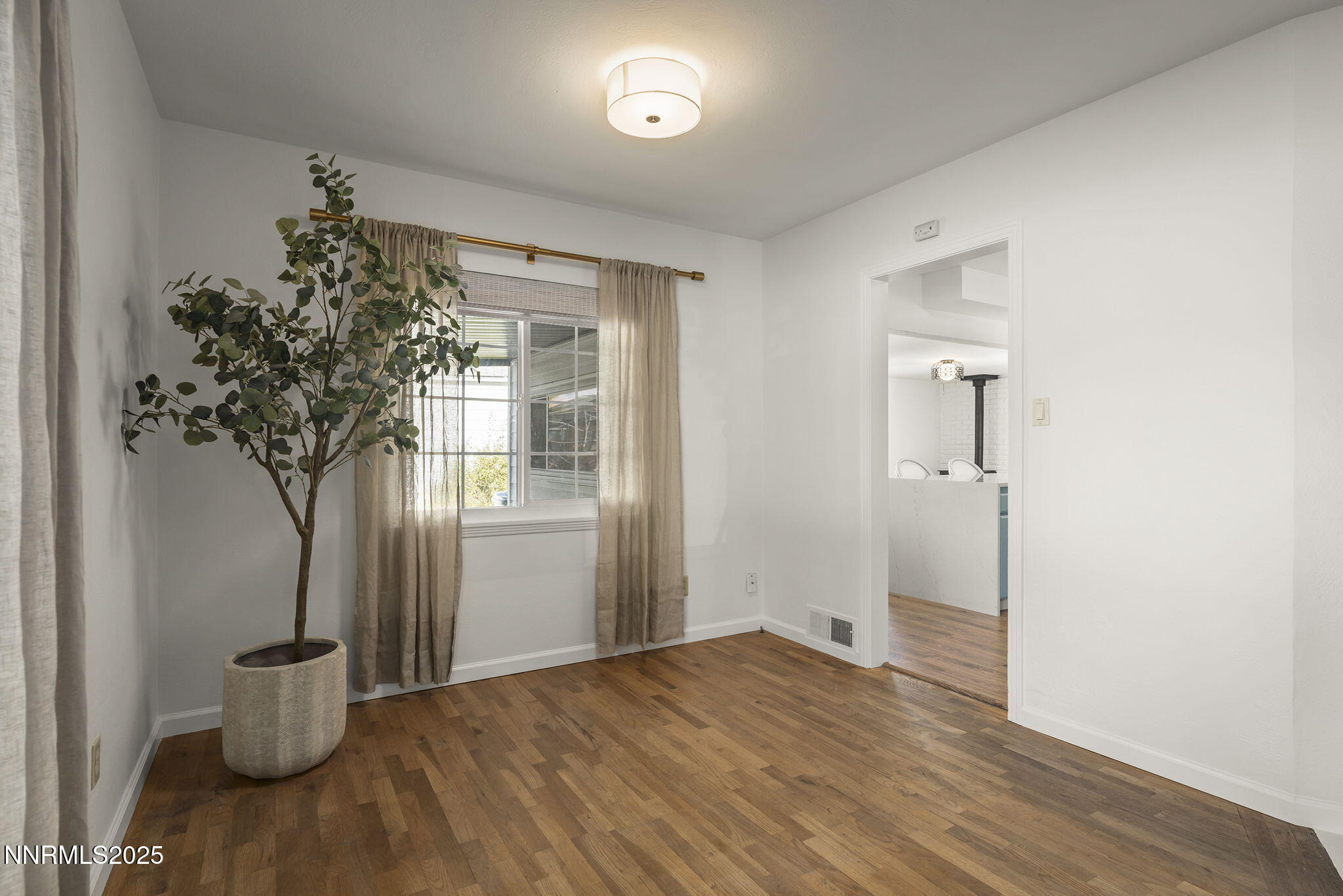 640 Robin Street Reno, NV 89509 - Photo 8 of 25 a view of empty room with wooden floor and fan