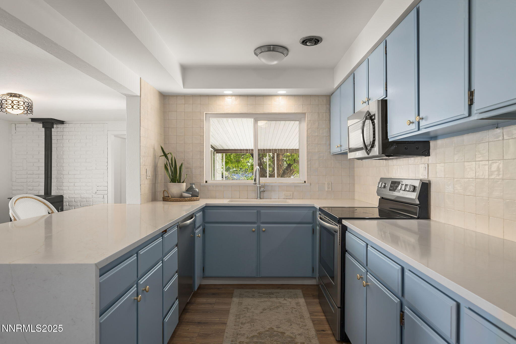 640 Robin Street Reno, NV 89509 - Photo 10 of 25 a kitchen with a sink stove top oven and cabinets