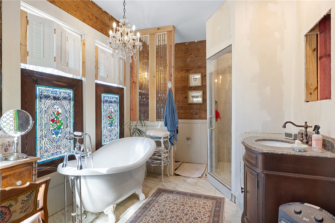 1017 Water Street Navasota, TX 77868 - Photo 19 of 28 a bathroom with a sink a toilet a mirror and a shower