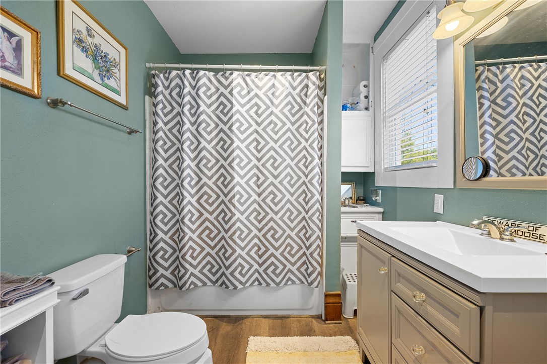 1017 Water Street Navasota, TX 77868 - Photo 21 of 28 a bathroom with a sink a toilet and a shower curtain