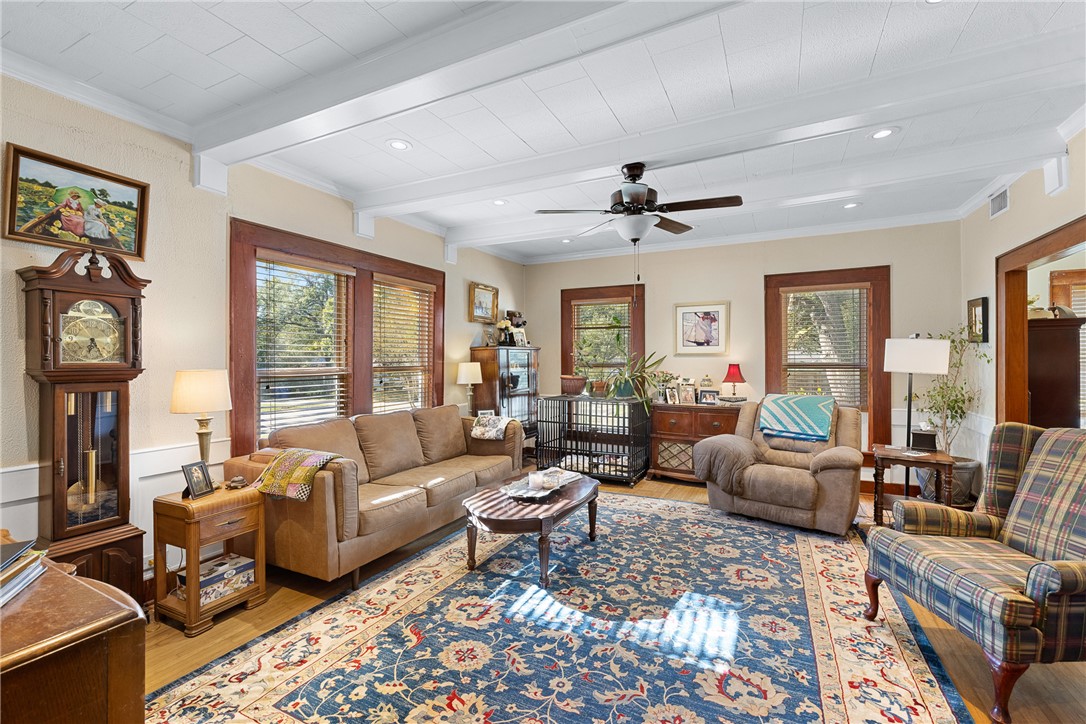 1017 Water Street Navasota, TX 77868 - Photo 8 of 28 a living room with furniture a fireplace and a large window
