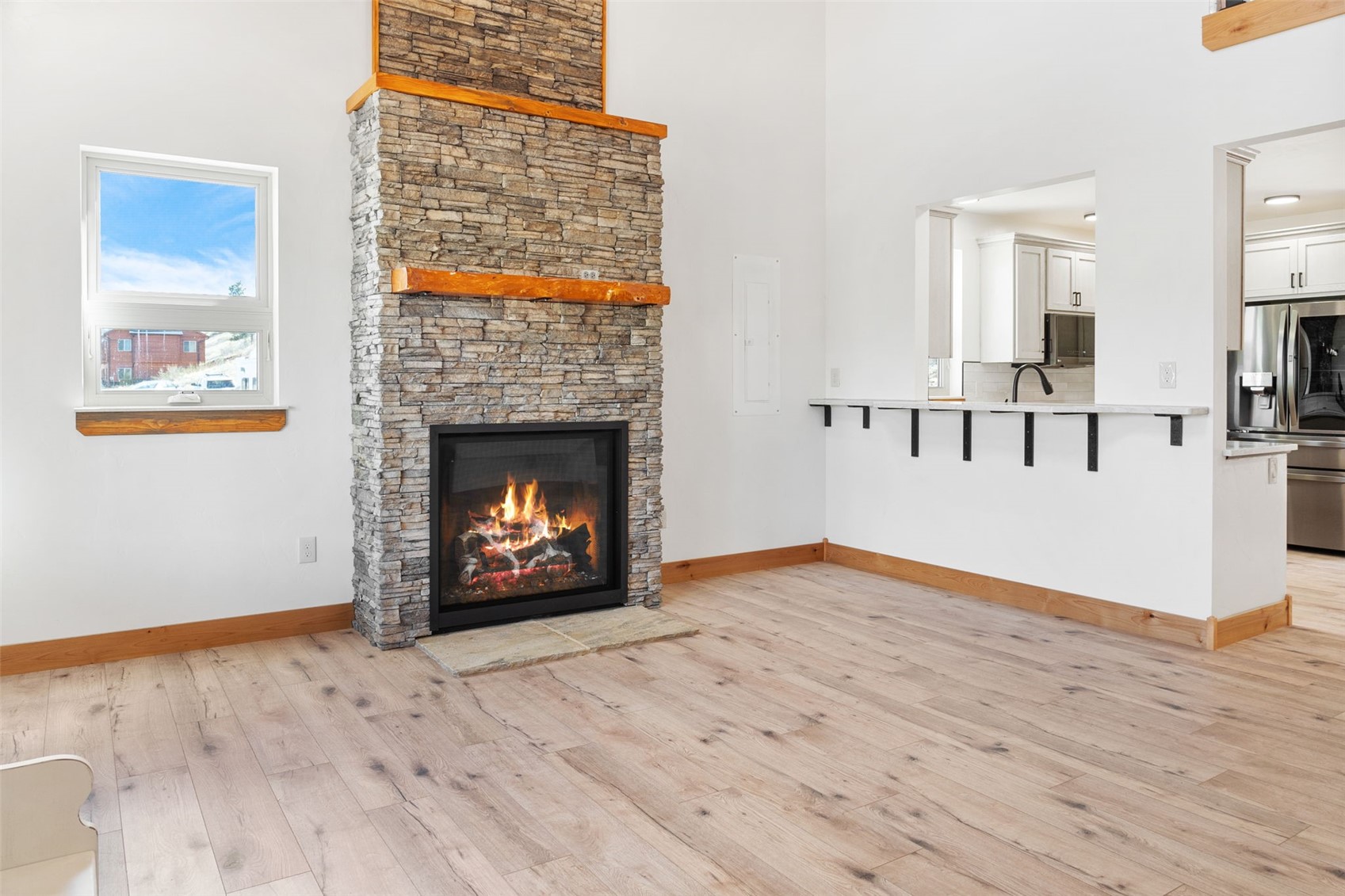 3415 Redhill Road Fairplay, CO 80440 - Photo 10 of 50 a view of an empty room with wooden floor fireplace and a window