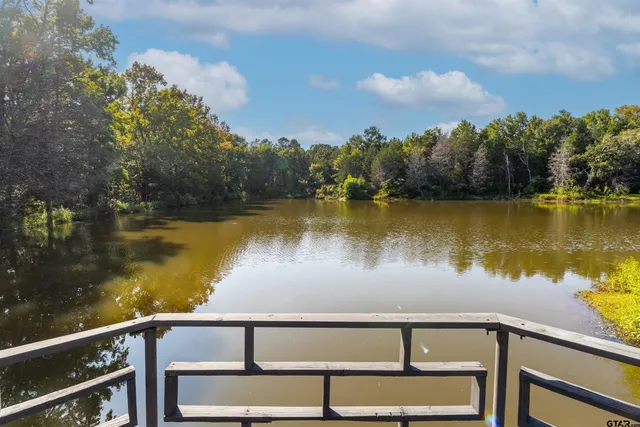 a view of a lake with houses in the back