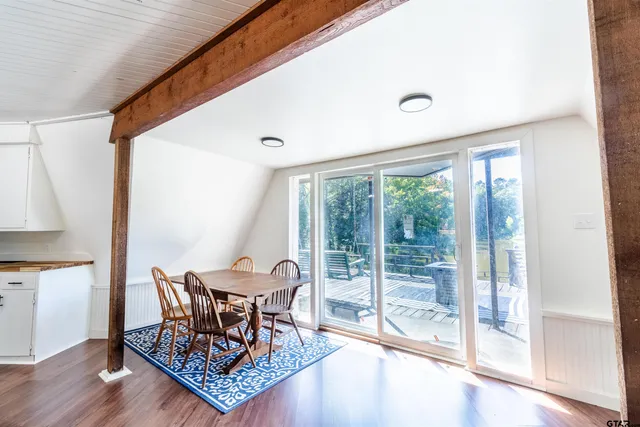 a dining room with furniture and front door view