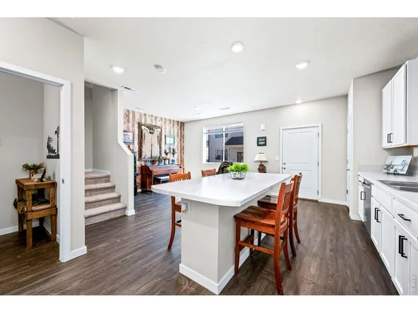 a open kitchen with a table and chairs