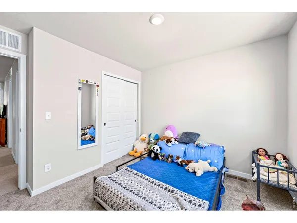 a bedroom with furniture and a wooden floor