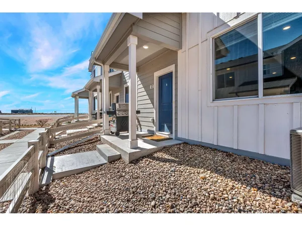 a view of a house with backyard and parking