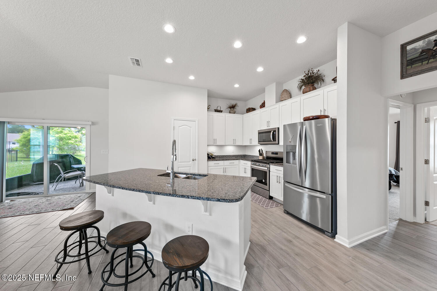 352 Chasewood Drive St. Augustine, FL 32095 - Photo 13 of 29 a kitchen with refrigerator and chairs