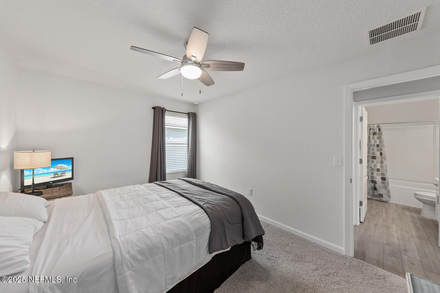 352 Chasewood Drive St. Augustine, FL 32095 - Photo 18 of 29 a bedroom with a bed and a window